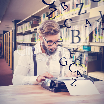 Composite image of hipster smoking pipe while working on typewri