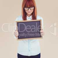 Composite image of smiling hipster woman holding blackboard