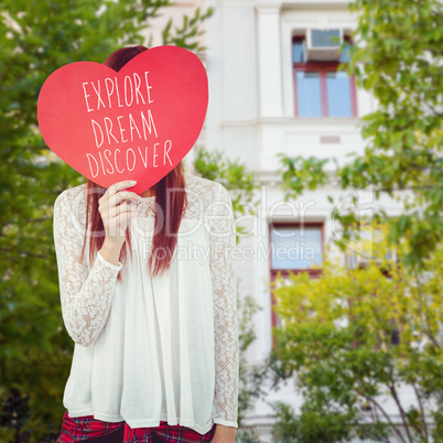 Composite image of smiling hipster woman behind a big red heart