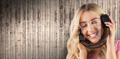 Composite image of a beautiful woman enjoying listening her music
