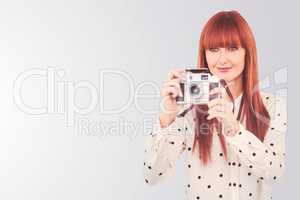 Composite image of attractive hipster woman using old fashioned