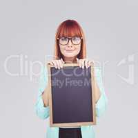 Composite image of smiling hipster woman holding blackboard