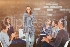 Composite image of  rehab group applauding delighted woman stand