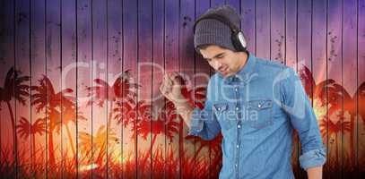 Composite image of hipster wearing headphones enjoying music