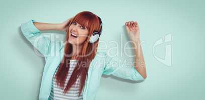Composite image of happy hipster woman listening music with head