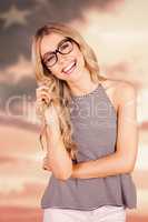 Composite image of gorgeous smiling blonde hipster playing with