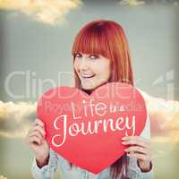 Composite image of attractive hipster woman behind a red heart