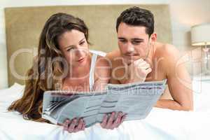 Smiling couple lying in bed