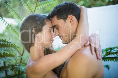 Young couple embracing in garden