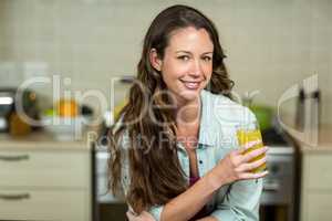 Portrait of young woman drinking juice