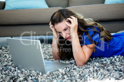 stressed woman looking at her laptop