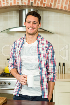 Portrait of young man holding a cup of tea