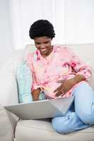 Pregnant woman using laptop