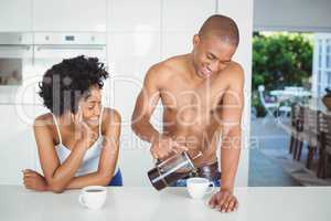 Happy couple drinking coffee in the kitchen