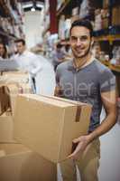 Smiling man carrying box