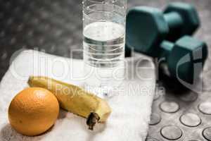 Fruit, water and dumbbells