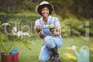 Smiling woman crouching in the garden