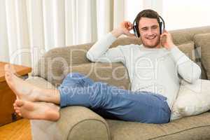 Young man feeling relaxed while listening to music