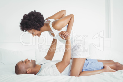 Happy couple playing on the bed