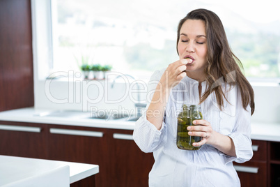 Pregnant woman eating pickles