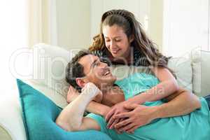 Young couple embracing on sofa