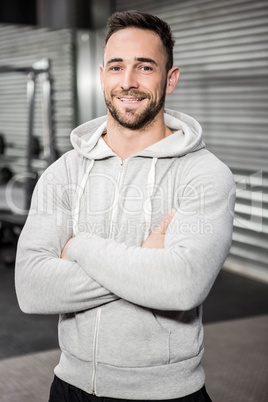 Smiling man with arms crossed