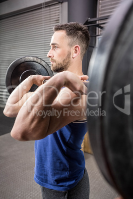 Muscular man lifting barbell