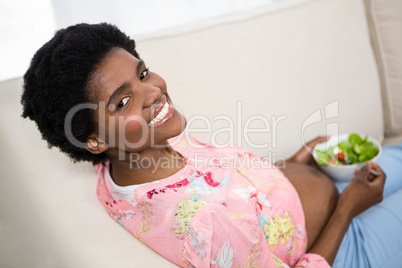 Pregnant woman eating salad