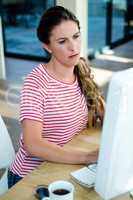 woman staring intently at her computer