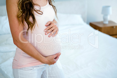 pregnant woman holding her bump