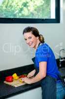 smiling woman preparing vegetables for dinner