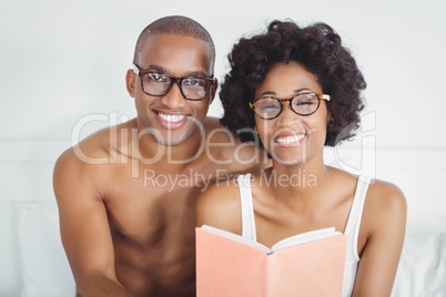 happy couple reading a book together