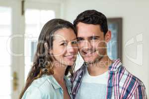Portrait of young couple smiling in living room