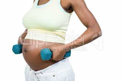 Pregnant woman lifting dumbbell