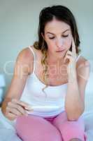 anxious woman holding a pregnancy test