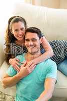 Happy young couple enjoying together in living room