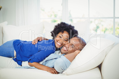 happy couple lying on the sofa