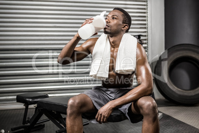 Shirtless man drinking protein shake