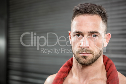 Portrait of shirtless man with battle rope around neck