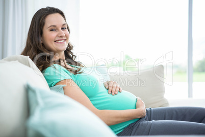 Pregnant woman sitting on couch