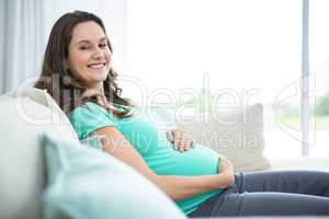 Pregnant woman sitting on couch