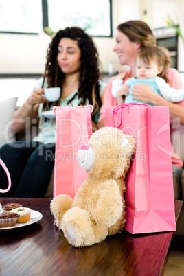 Two women and a baby surrounded by gifts