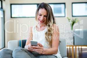 smiling woman looking at her mobile phone