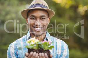 Smiling man holding flowers