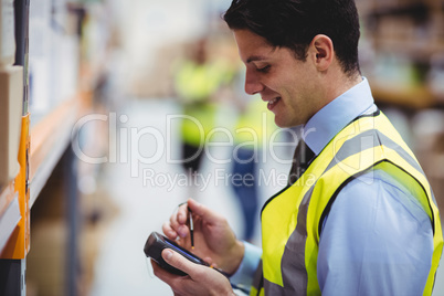 Warehouse worker using hand scanner