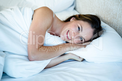 smiling woman lying in herr bed