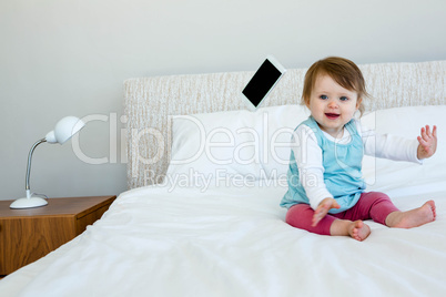 adorable baby giggling and throwing a phone