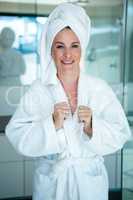 woman wearing a dressing gown smiling at the camera