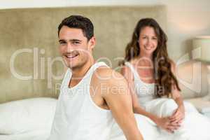 Portrait of young couple relaxing on bed