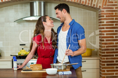 Happy couple laughing in kitchen